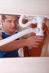 Plumber installing a sink